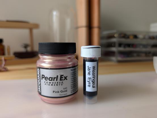 Pearl Ex shimmer powder in pink gold next to a sample of Wearingeul Jane Eyre ink.