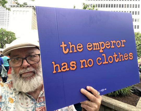 Selfie with sign: "the emperor has no clothes"