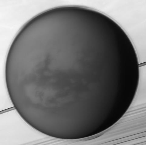 2025 May 3

Titan: Moon over Saturn
 * Image Credit: NASA, JPL-Caltech, Space Science Institute

Explanation: 
Like Earth's moon, Saturn's largest moon Titan is locked in synchronous rotation with its planet. This mosaic of images recorded by the Cassini spacecraft in May of 2012 shows its anti-Saturn side, the side always facing away from the ringed gas giant. The only moon in the solar system with a dense atmosphere, Titan is the only solar system world besides Earth known to have standing bodies of liquid on its surface and an earthlike cycle of liquid rain and evaporation. Its high altitude layer of atmospheric haze is evident in the Cassini view of the 5,000 kilometer diameter moon over Saturn's rings and cloud tops. Near center is the dark dune-filled region known as Shangri-La. The Cassini-delivered Huygens probe rests below and left of center, after the most distant landing for a spacecraft from Earth. 

 Authors & editors: Robert Nemiroff (MTU) & Jerry Bonnell (UMCP)
NASA Official: Amber Straughn Specific rights apply.
NASA Web Privacy Policy and Important Notices
A service of: ASD at NASA / GSFC,
NASA Science Activation
& Michigan Tech. U.