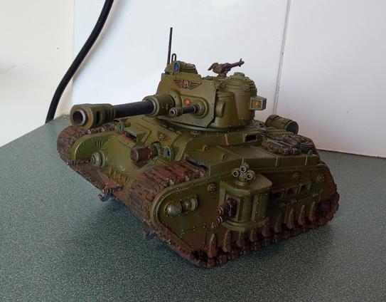 A large green tank with a lot of guns.