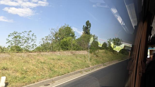 A sole track next to the road over the bridge.