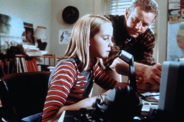 a scene from the movie Contact, with a young Ham Radio operator Ellie Arroway on the mic calling out “CQ… CQ… this is W9GFO here… is anybody out there…?” while her father watches on
