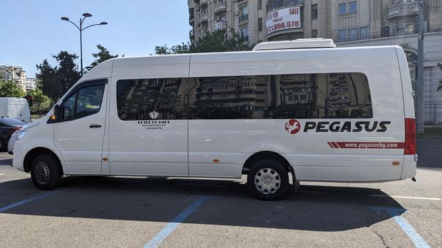 A white mini bus on a parking in Bucuresti.