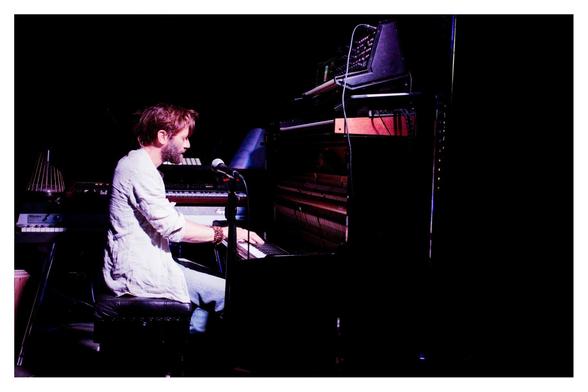 Benji Bower at the piano & surrounded by various electronicals during the first concert at the village hall.