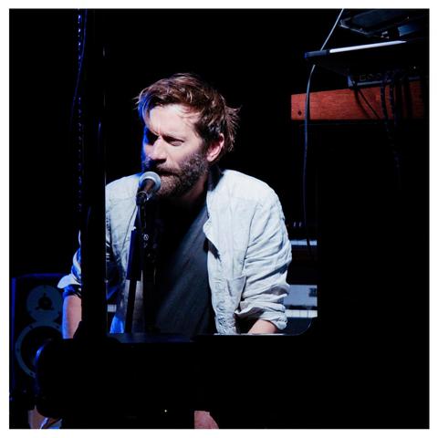 Benji Bower at the mic & surrounded by various electronicals during the first concert at the village hall.