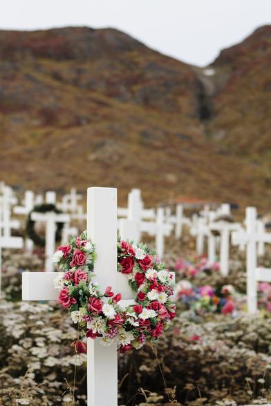 white crosses and flowers of a graveyard in greenland