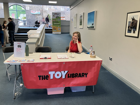 Our education coordinator Gwendolyn at the check-in station of our Swap&Play event happening today in Limerick. The banner says « The Toy Library »