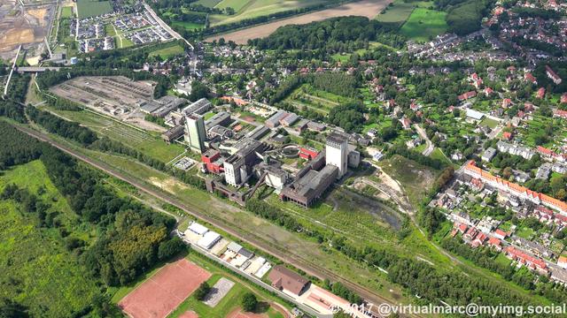 An aerial photo of the Westerholt mine, sourrounded by living quaters and wood/grass landscape.