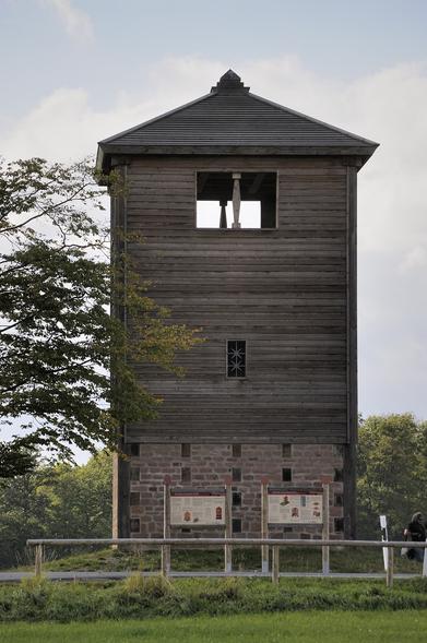 Limeswachtposten Wp 10/15, Rekonstruktion nahe der gesuchten Ortschaft. Davor sind zwei Informationstafeln.
(Bild: DerHexer, Wikimedia Commons, CC-by-sa 4.0, 2012)