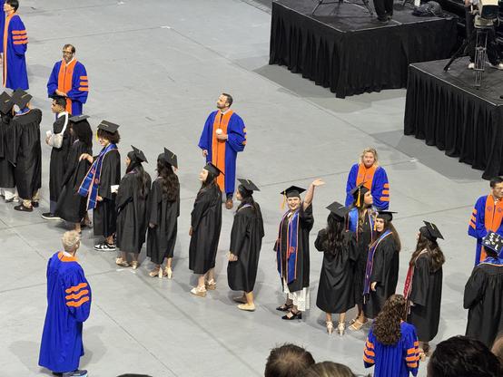 Daughter waving from graduational processional