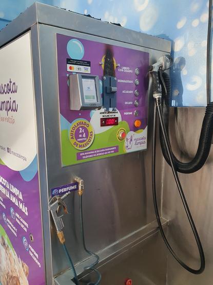 The controls of the dog washing apparatus showing 5 stages of doggy cleanliness: wash with shampoo, anti-parasite, rince, dry, perfume. It takes coins or credit cards.