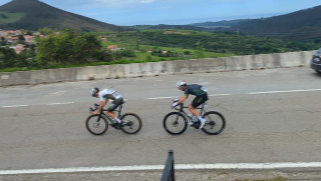 The two leaders of a junior cycle race, with hills and the sea in the background, AllezAlles