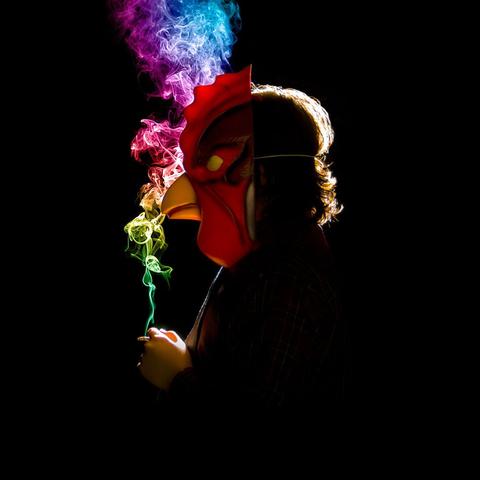 Album cover for 2011 Beat Tape by Brock Berrigan. A silhouetted figure wears a red rooster mask and stands in profile against a black background. They hold a cigarette that emits a trail of multicolored smoke—green, yellow, red, purple, and blue—swirling upward in vibrant contrast to the darkness.