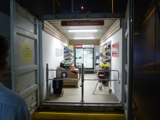 an exhibit at the Maritime Museum, that uses a shipping container to create a tiny Brugsen's grocery shop containing a wide range of goods that arrive via container ship.