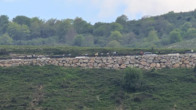 A blurred phone at max zoom if the hill side across the valley of cyclist climb the last hill into the finish, don't know who the leader is but more cowbells to them all Allez Allez!