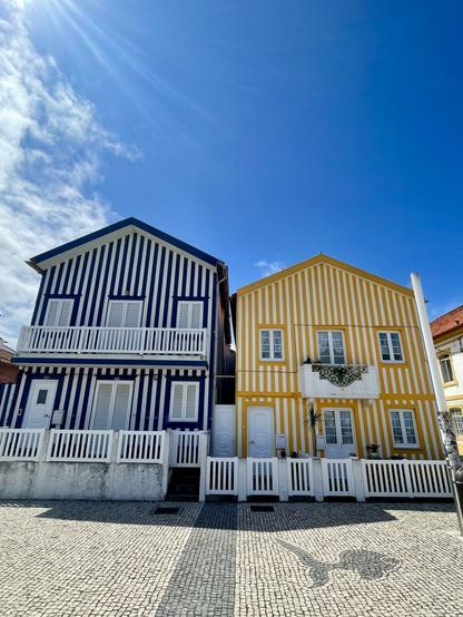 blue and white stripped house, yellow and white stripped house, blue skies