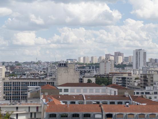 Cityscape with apartment buildings under a cloudy sky.