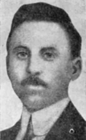 Portrait of Salsedo, with mustache, short hair, making eye contact