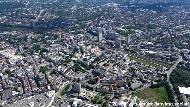 An aerial photo of the Essen Central station with the Postbank and Evonik Buildings,
The big round tower is the central of innogy (former RWE tower).
Right of it you can see the Aalto Theater and the Philharmonic of Essen.