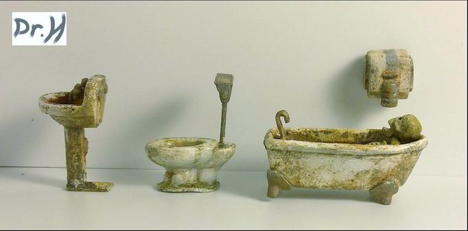 Side views of the sink, toilet, bath and the hand-dryer on the "wall".