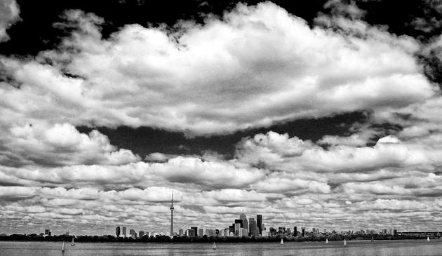 Picture of the Toronto harbour taken from the Island showing a gigantic cloud over the city.