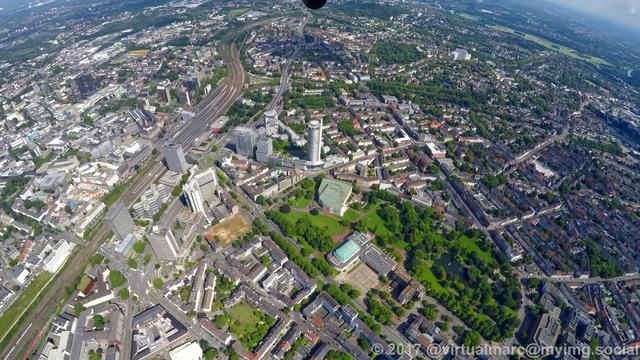 An aerial photo of the center of Essen. In the center you can See the Aalto Theater and the Philharmonic of Essen with a green park around.
Behind the Aalto Theater is a big round tower which is the headquater of Innogy, this is the former RWE Tower. On The left you see a big train station, this is the Essen central station.