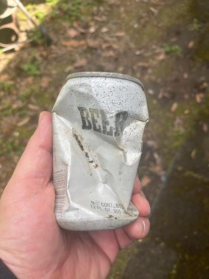 Picture of crumpled “generic” beer can. White with black letters