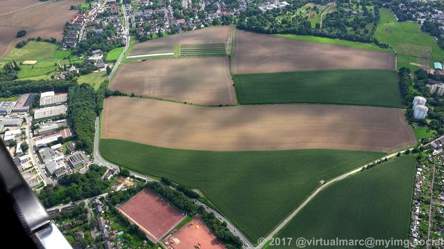 An aerial photo of a farm yard, the Ridderhof, with two big silos on the right.