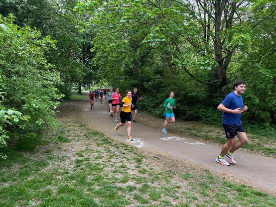 Photo of Emily running towards the camera. She is wearing her apricot parkrun tshirt.