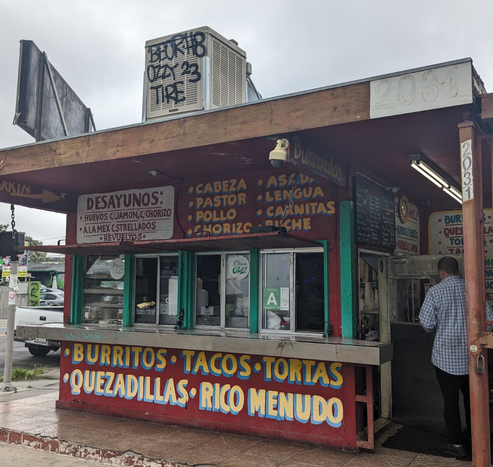 Taco stand with menus hand painted on it