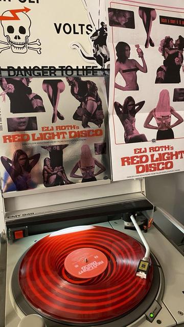 Rote Vinyl Schallplatte mit dem Titel „Eli Roth‘s Red Light Disco-Dancefloor Seductions From Italian Sexploitation Cinema“ auf einem Plattenspieler.