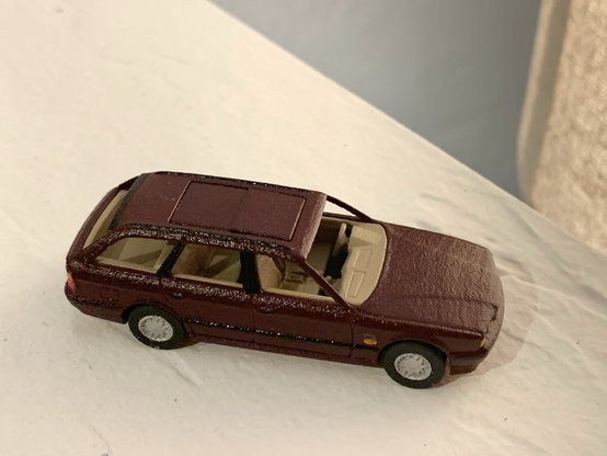 A burgundy 3D-printed 1:64-scale BMW 525iT with its dual-panel sunroof closed.