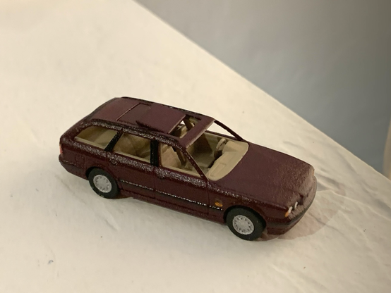 A burgundy 3D-printed 1:64-scale BMW 525iT with the front panel of its dual-panel sunroof open.