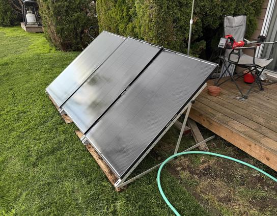 Three 200w solar panels all cleaned up and resting in their new spot out back..