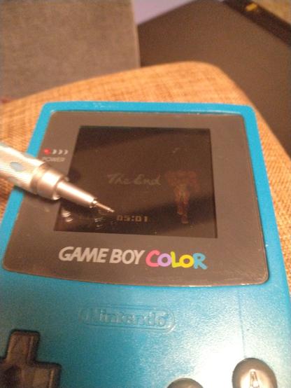 Photo of a Game Boy Color with "The End", Samus, and the text "Time: 5:01"
