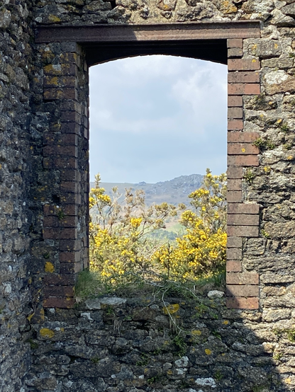 Looking out over the moor through a window frame ifrom an old tin mining building