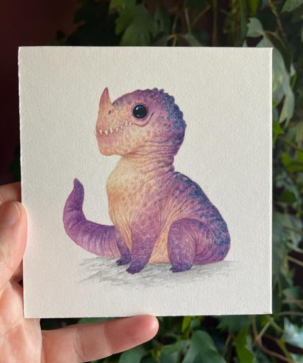 A chubby little purple dragon with a pale pink tummy, with big black shiny eyes and a little horn
