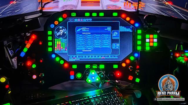 A colourful button box surrounding a display that shows various data from the game running in the background stretched over several own displays for immersion.
