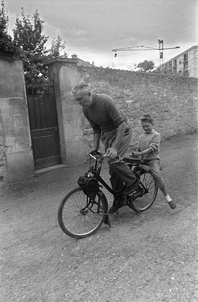 SAINT-GERMAIN-EN-LAYE, FRANCE: French actor and film director Jacques Tati and his son Pierre ride the 1960s a Solex, a motorized bicycle, near his house in Saint-Germain-en-Laye near Paris. Jacques Tatischeff (1908-1982) was one of the great icons of French cinema, a Gallic equivalent of Chaplin or Keaton, whose works as director, writer, and actor are regarded fondly by audiences as well as harder-to-please critics. Like a true film maker, Tati essentially made only one kind of film, in his case, the physical comedy. The main protagonist of all his movies is also his screen alter ego, the ubiquitous Monsieur Hulot. AFP PHOTO INTERCONTINENTALE (Photo credit should read AFP/AFP/Getty Images)