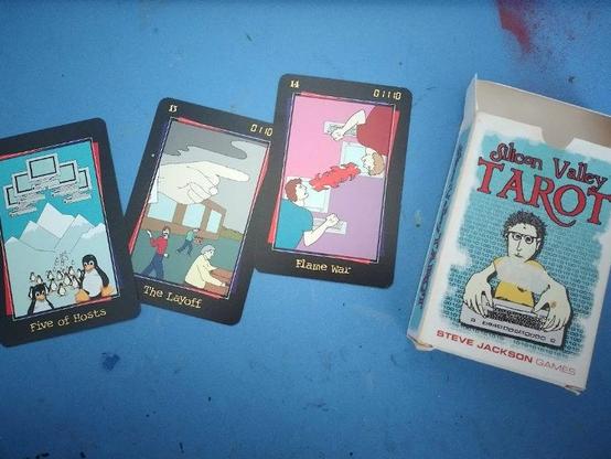 Box of Silicon Valley Tarot (by Steve Jackson Games, 1998), with cards: minor arcana Five of Hosts [with many Tux the Penguins], major arcana the Layoff [Death], Flame War [Temperance]
