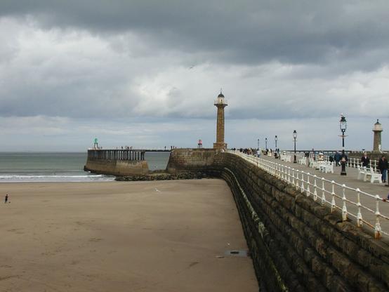 A view of the jetty or pier at Whitby jutting into the sea.