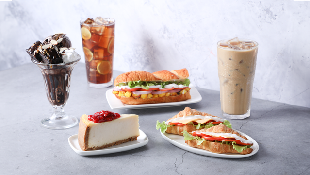 A tempting array of treats: ice cream sundae, iced drinks, sandwiches, and cheesecake.