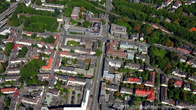 An aerial photo of the central region of Essen with multiple living and working houses with trees around.