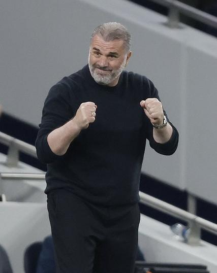 Ange Postecoglou clenching his fists in a slightly cheery positive way but his face isn’t quite sure.