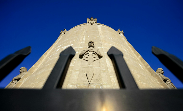 The Washburn Water Tower was built in 1932 and is guarded by eight guardians of health to protect from water pollutants. (Glen Stubbe/The Minnesota Star Tribune)

View is looking up the site of the concrete tower, at one of the Guardians of Health and a deep blue sky.