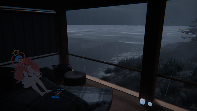 Picture of a bedroom with a big window having a view on a coast. It is rainy and an avatar is sitting on the bed with a game console near them.