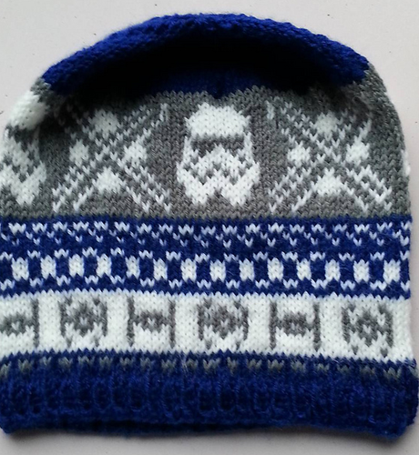 A knit hat, in blue white and grey, with a star wars motif. Posted in celebration of star wars day.