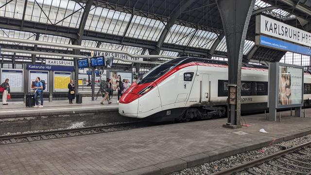 A shiny Stadler SMILE high speed train entering Karlsruhe on the opposite track.