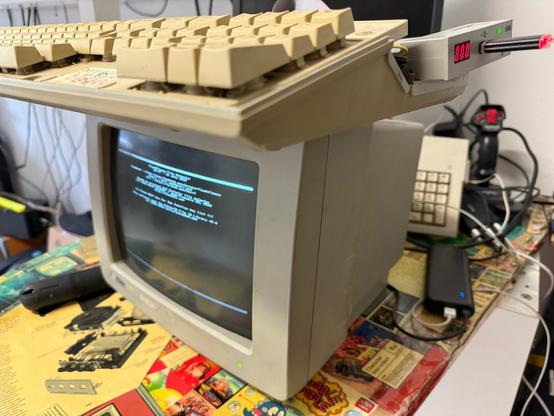 Opened AtariST 1040 on top of a SM124 monitor. A GoTek drive sticks out on the right and the screen shows the flashfloppy disk selector.