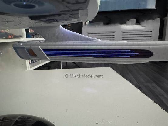 Inboard side of the starboard nacelle showing 5 blue lines lit up.
